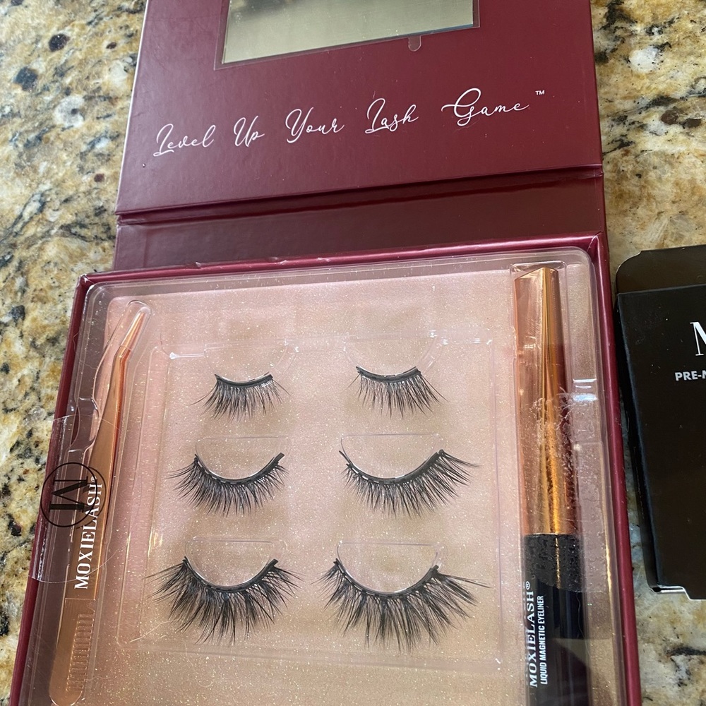 Brand new never worn. Moxie lash eyelashes, magnetic eyeliner and cleaning swabs